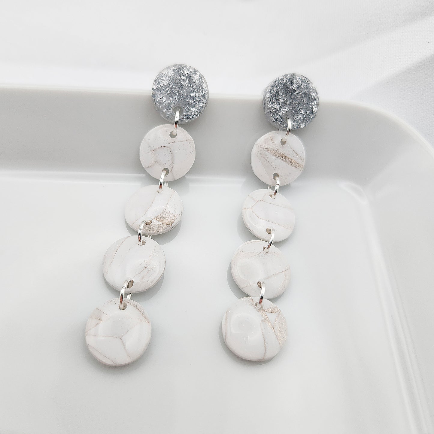 Dangle white earrings on silver studs