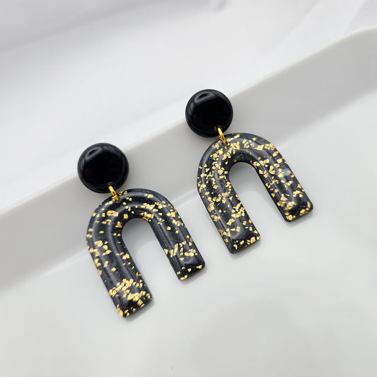 Black arch dangle earrings with gold shimmer