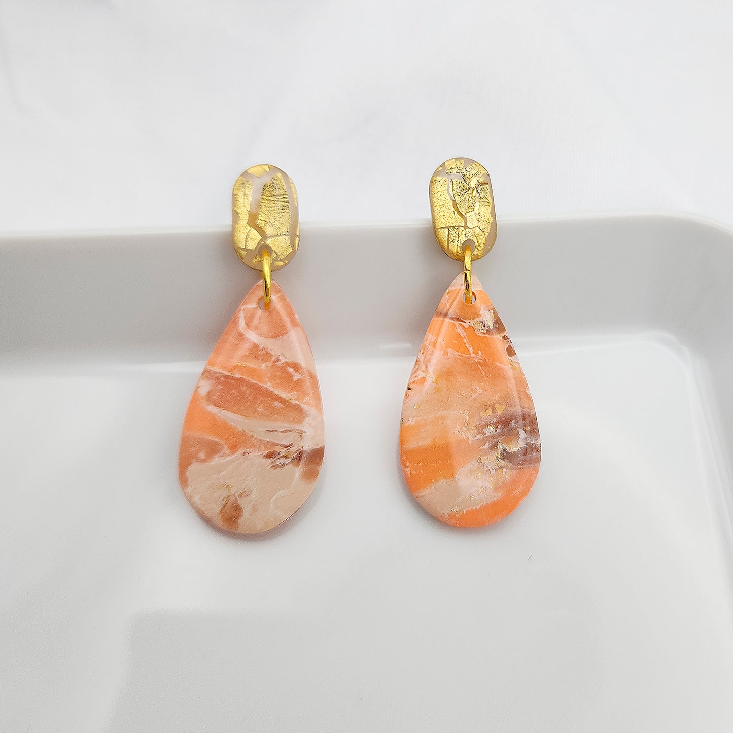 Dangle earrings on gold studs