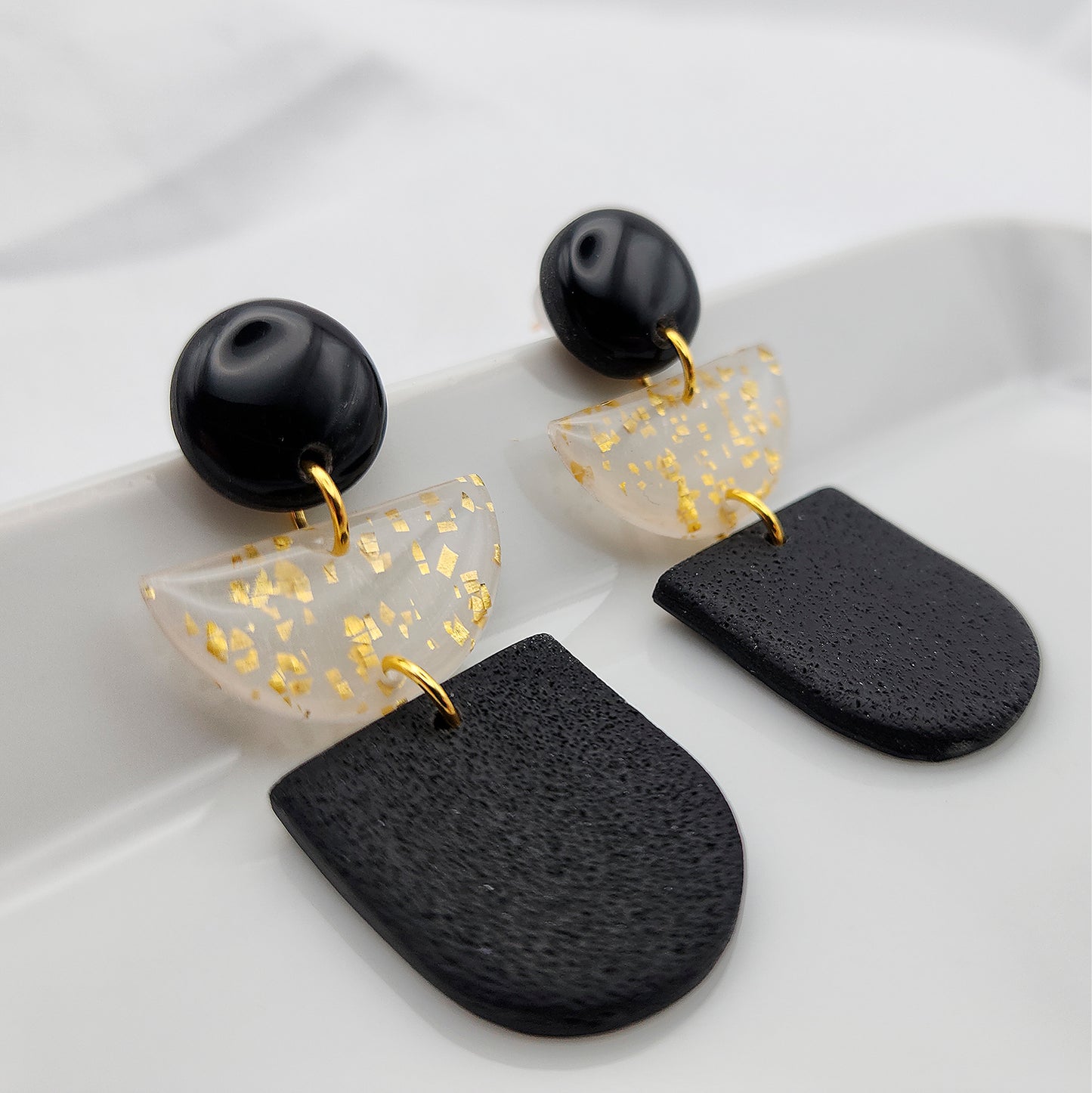 Dangle black earrings with semicircle with gold foil