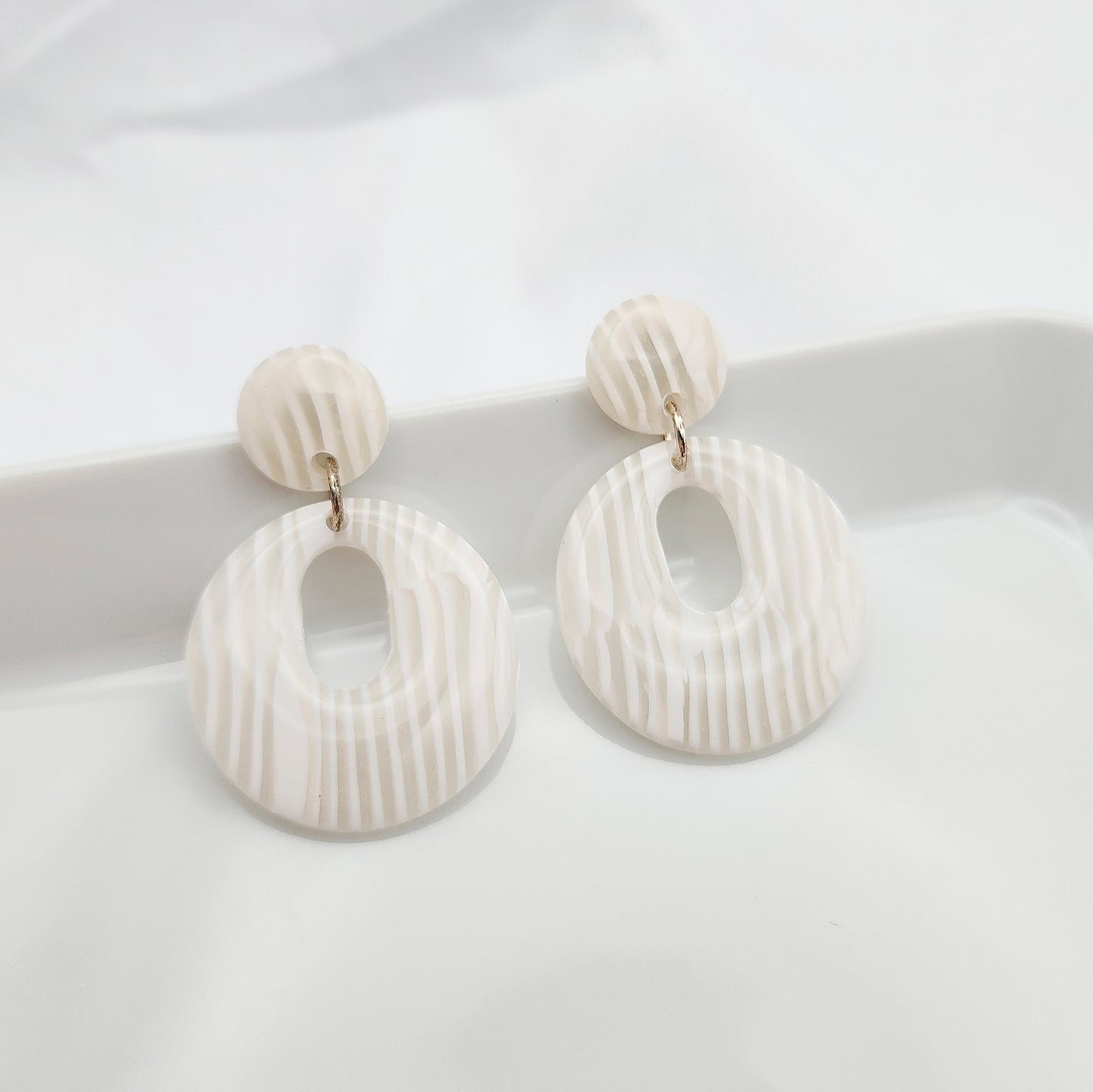 Hoop earrings in retro shape 60s style, ivory stripes