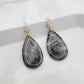 Dangle black stone clay earrings on gold studs