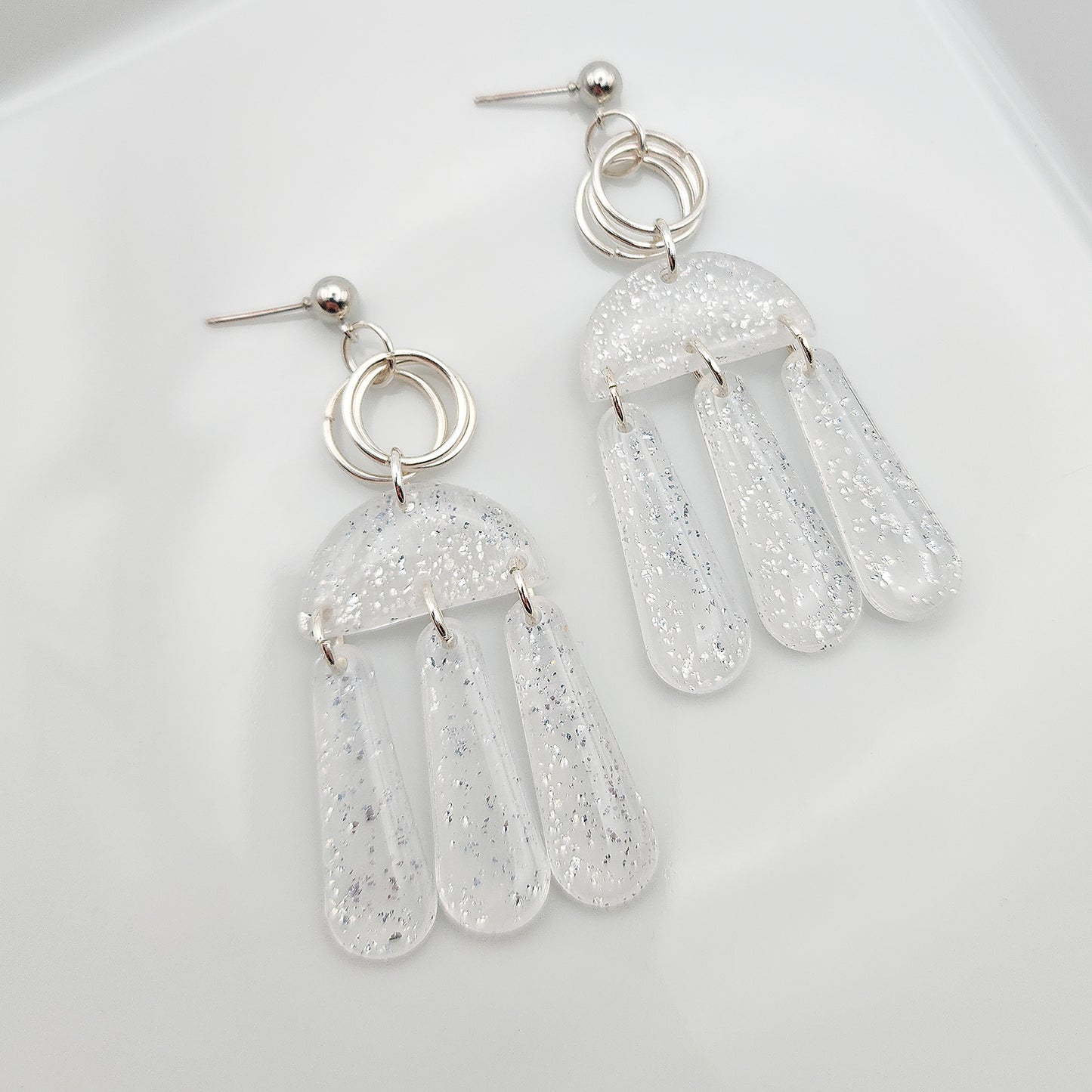 Dangle translucent earrings with silver shimmer