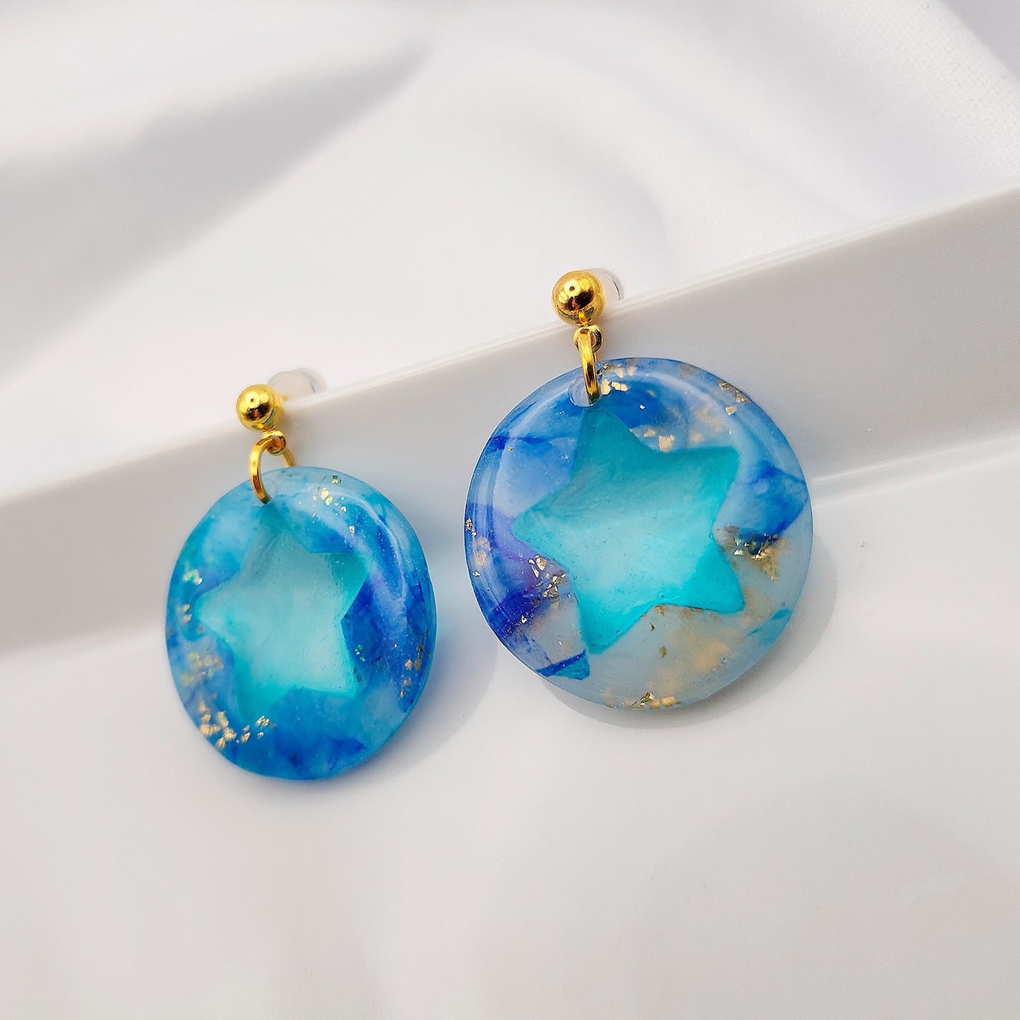 Blue earrings with a transparent middle in the form of a star