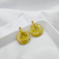 Green-yellow earrings with a transparent center