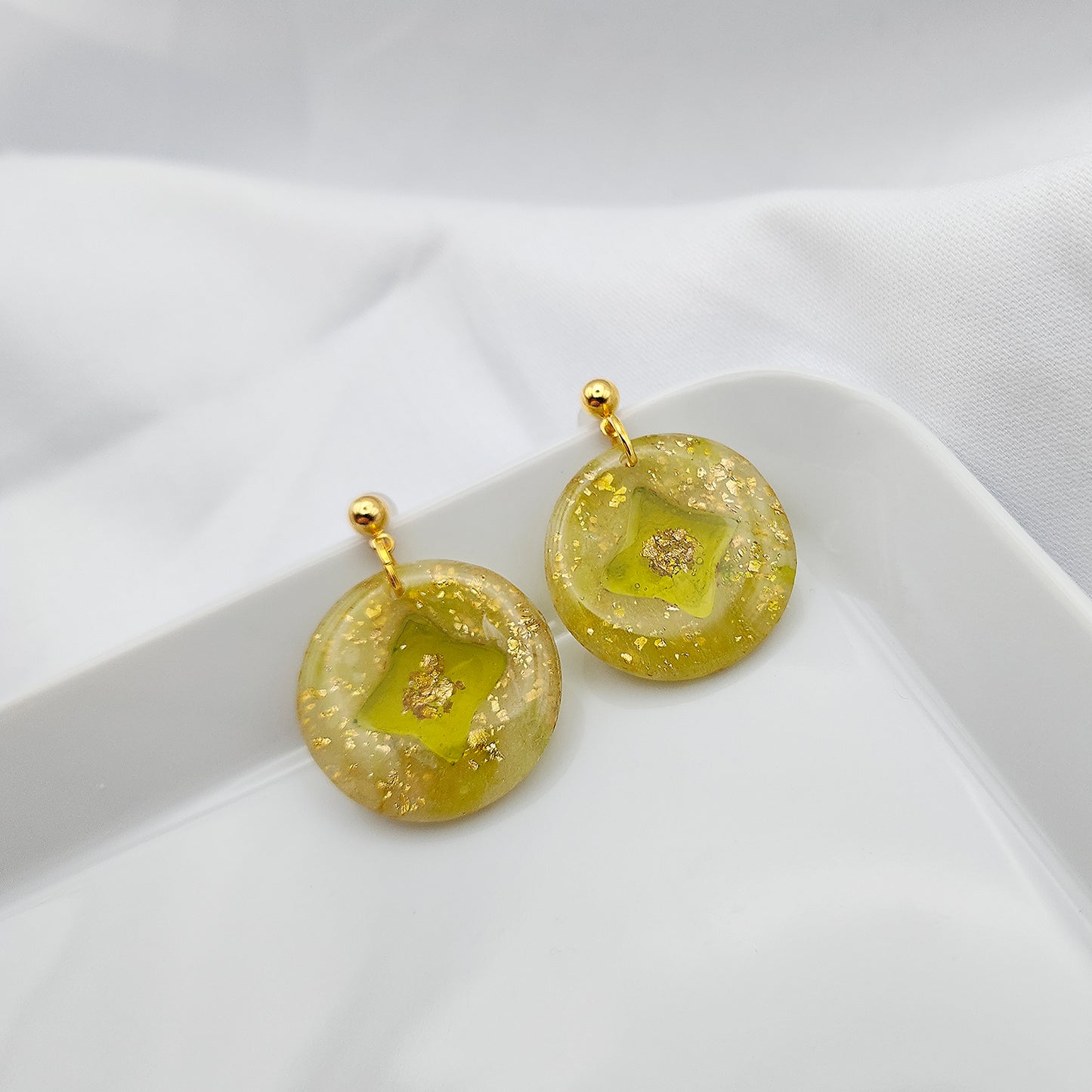 Green-yellow earrings with a transparent center