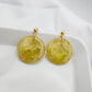 Green-yellow earrings with a transparent center