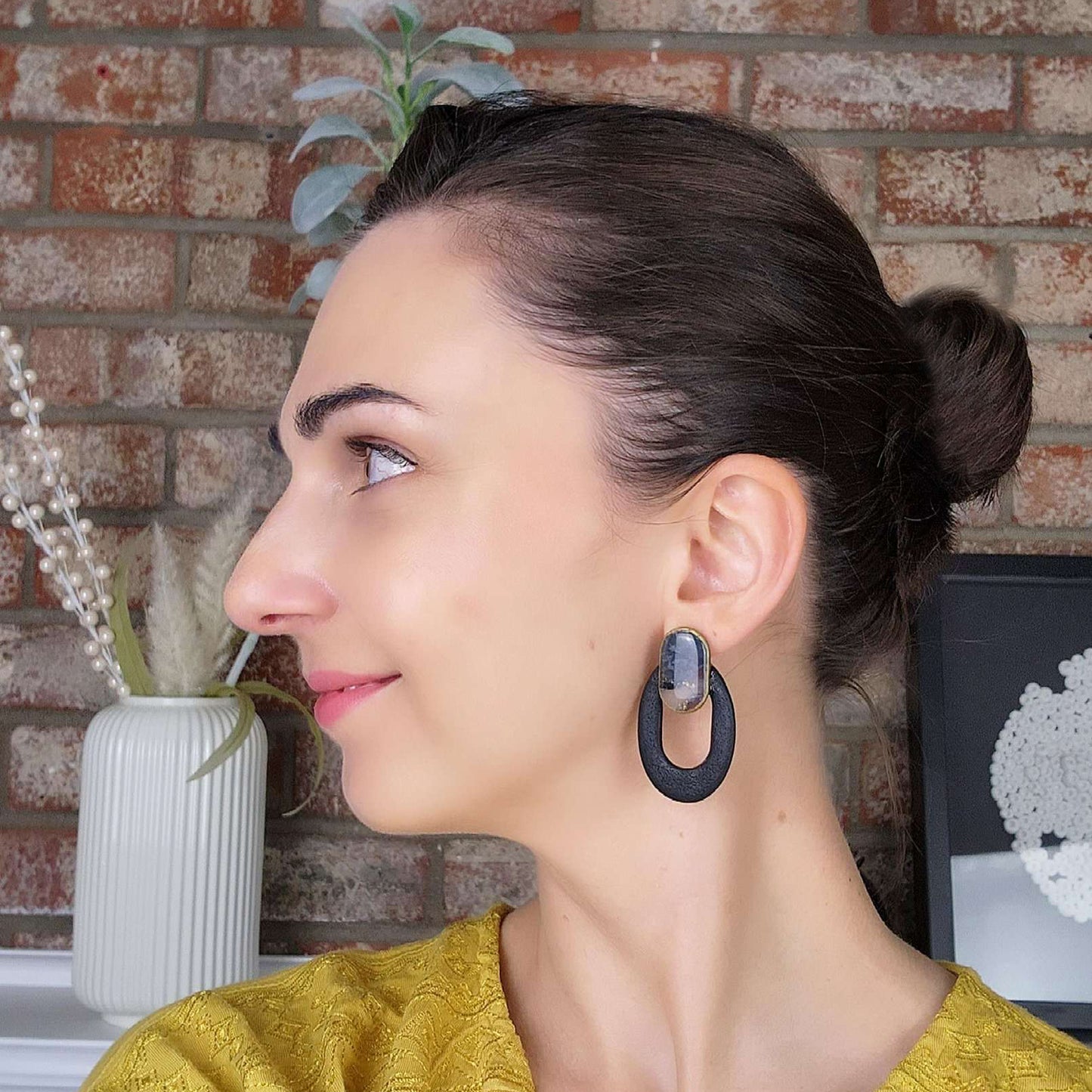 Black oval earrings with a clay stone stud