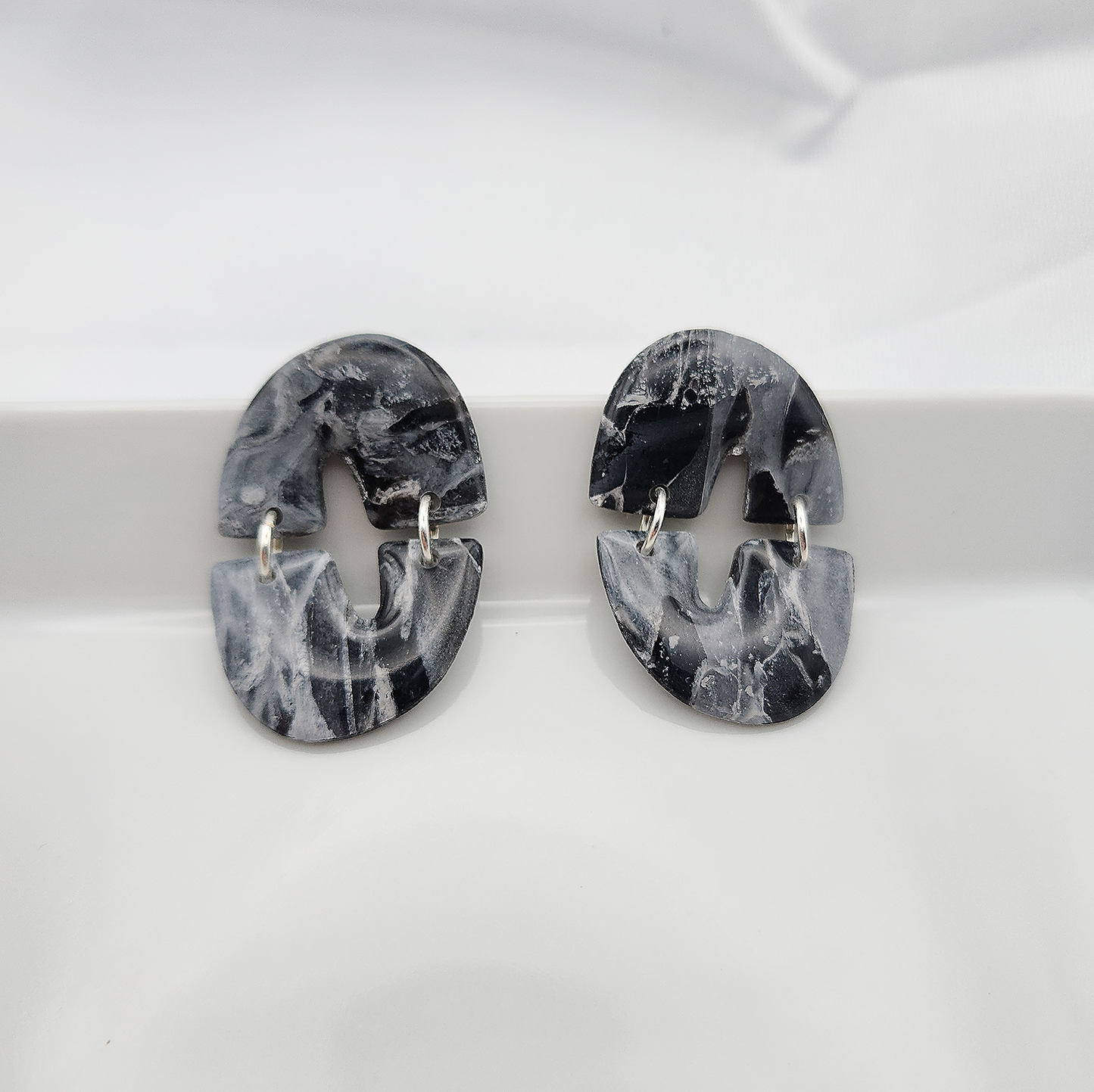 Smoothed shape dangle black stone clay earrings