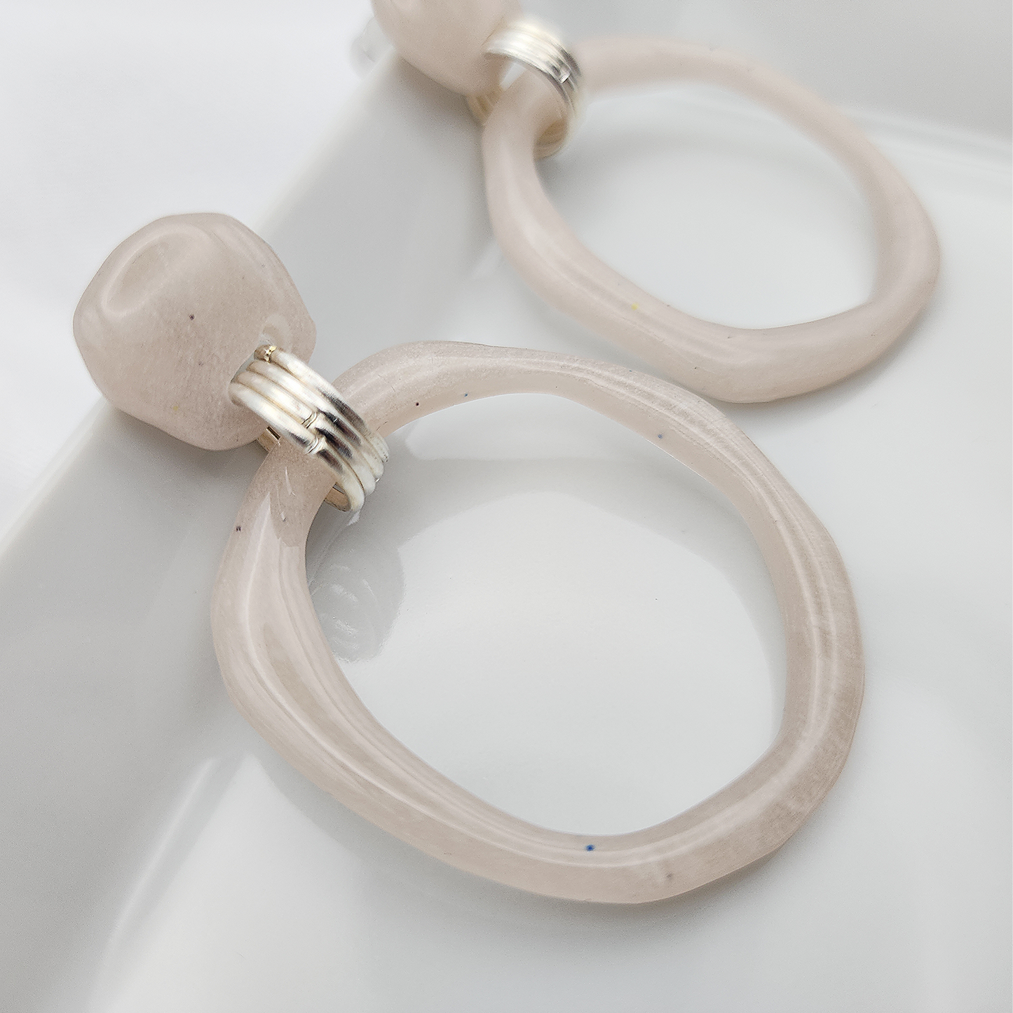 Statement dangling beige hoop earrings