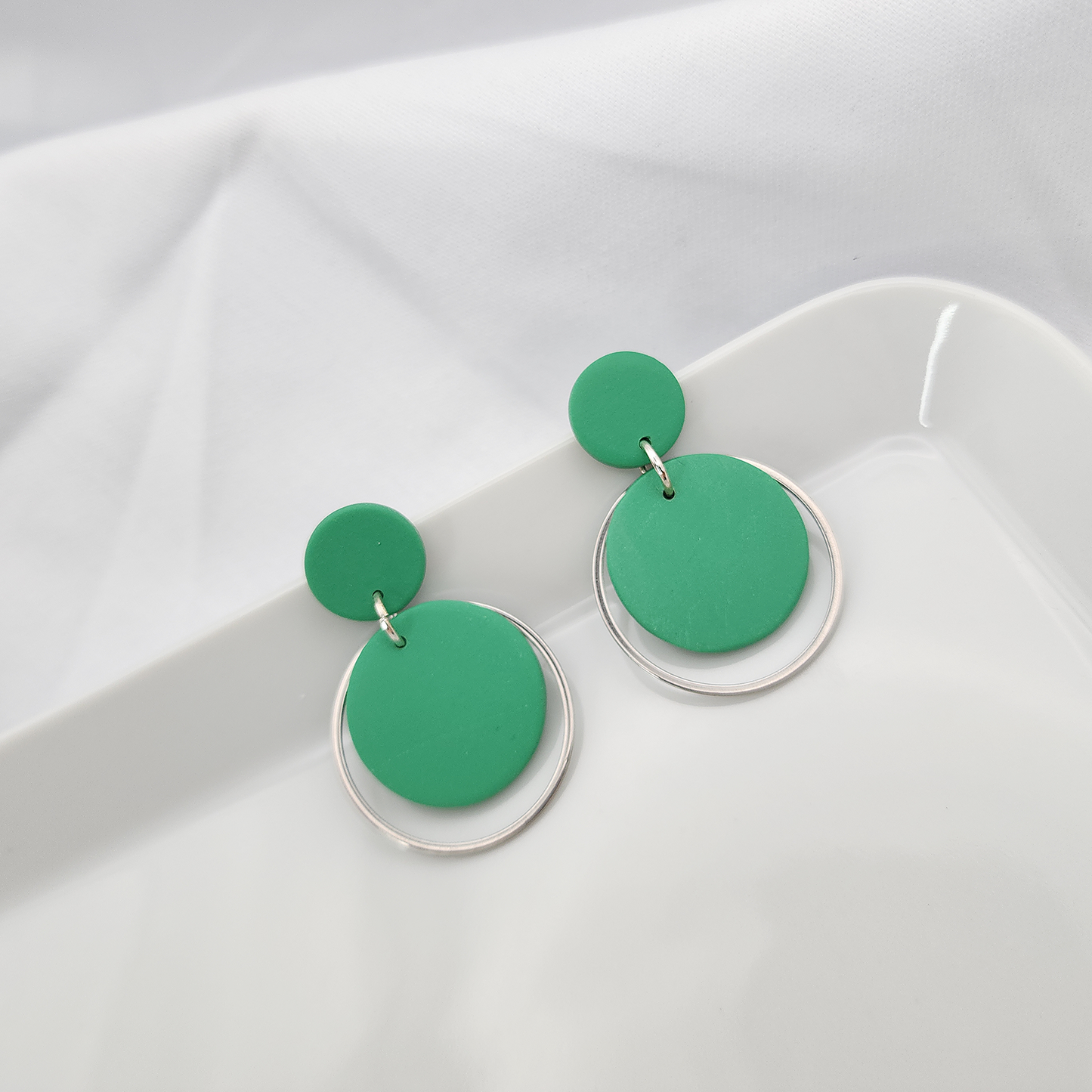 Round green dangle earrings