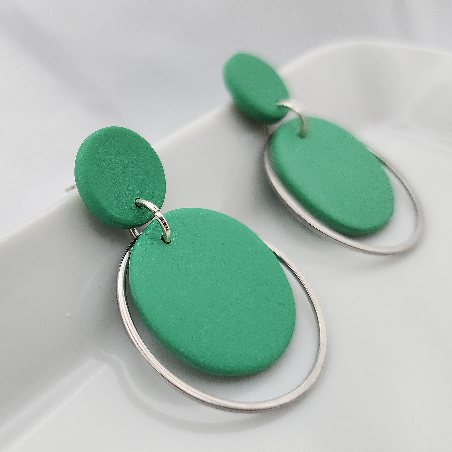 Round green dangle earrings