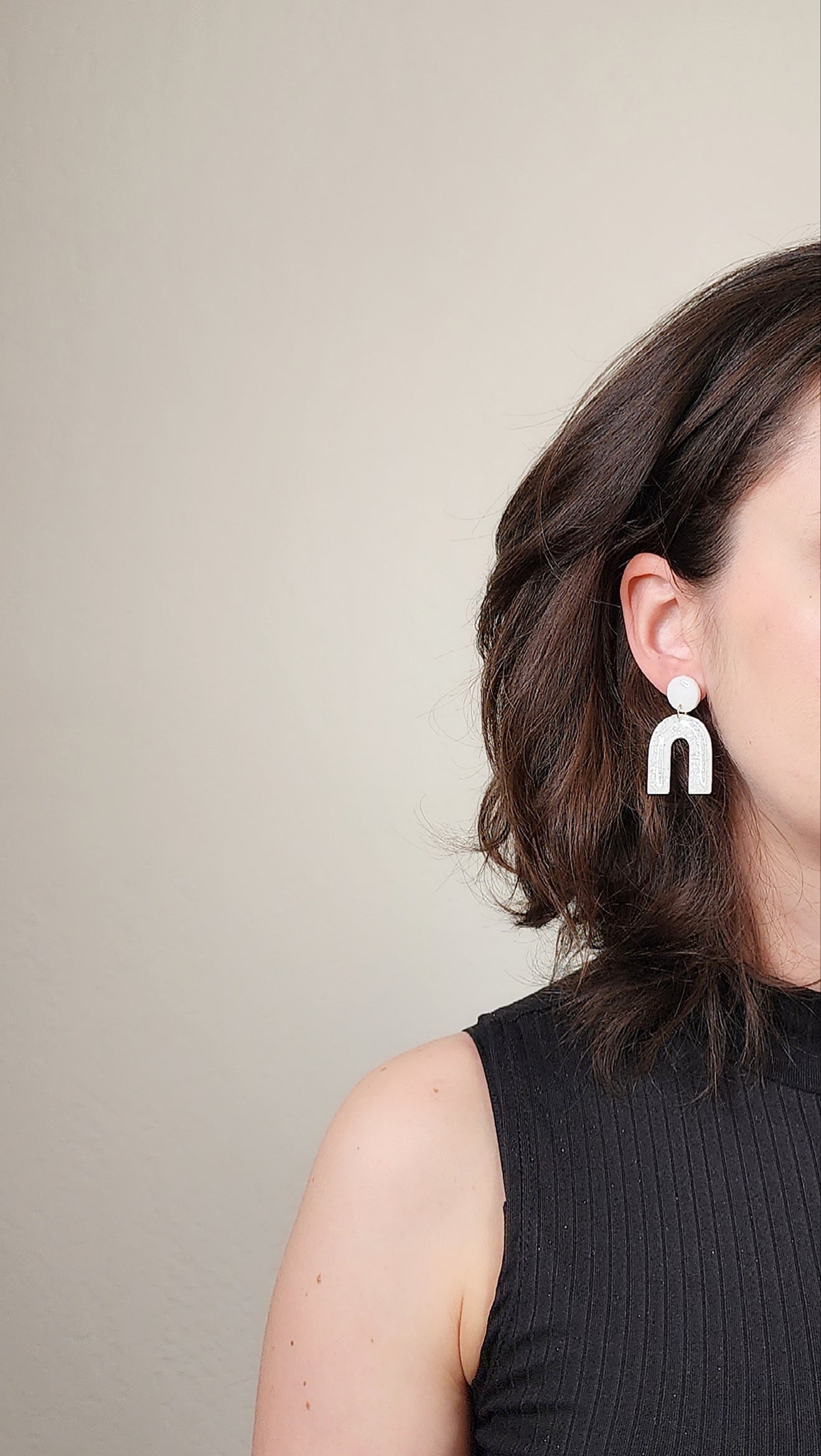 Dangle white arch earrings with silver shimmer