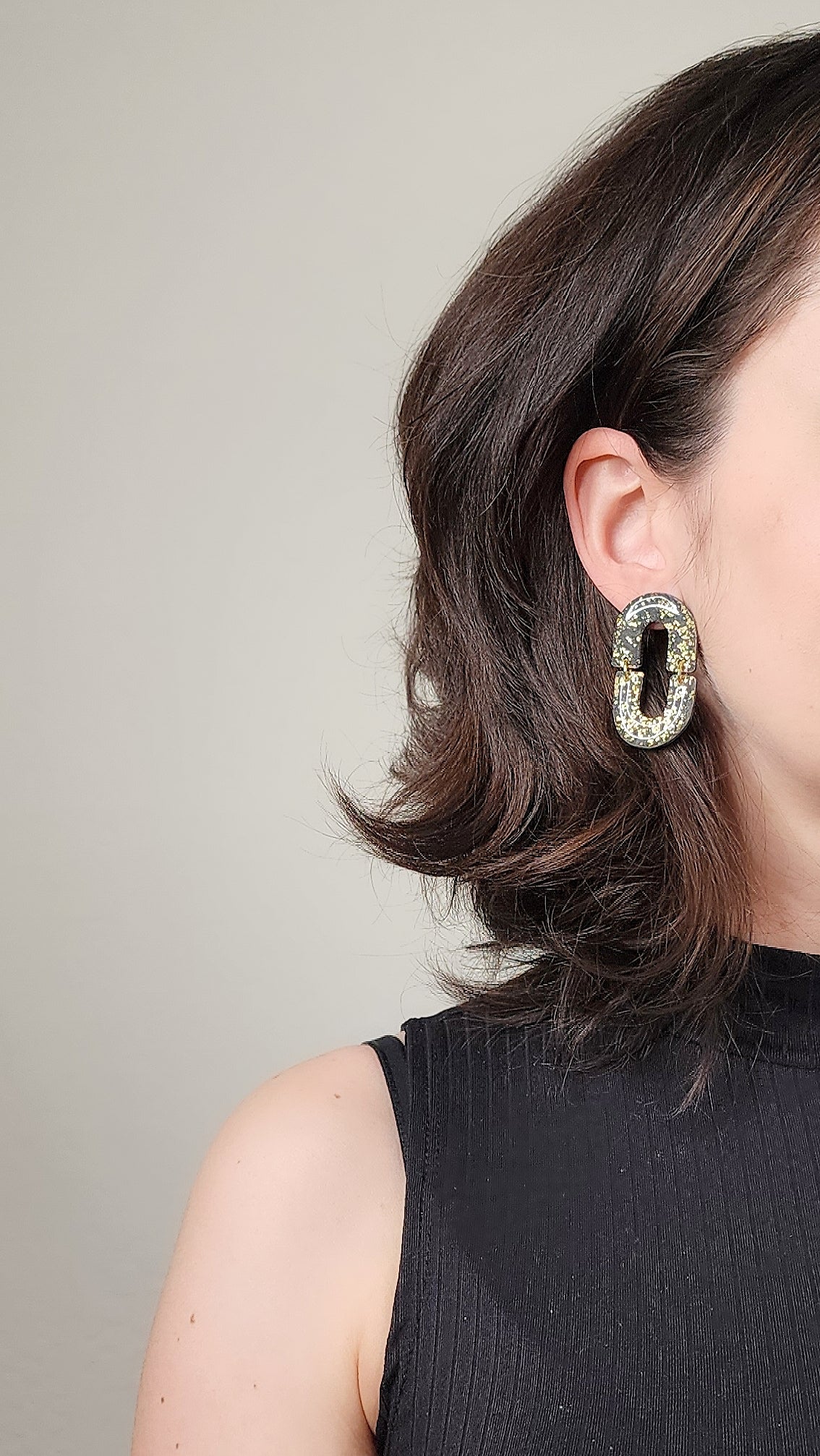 Oval dangle black earrings with gold shimmer