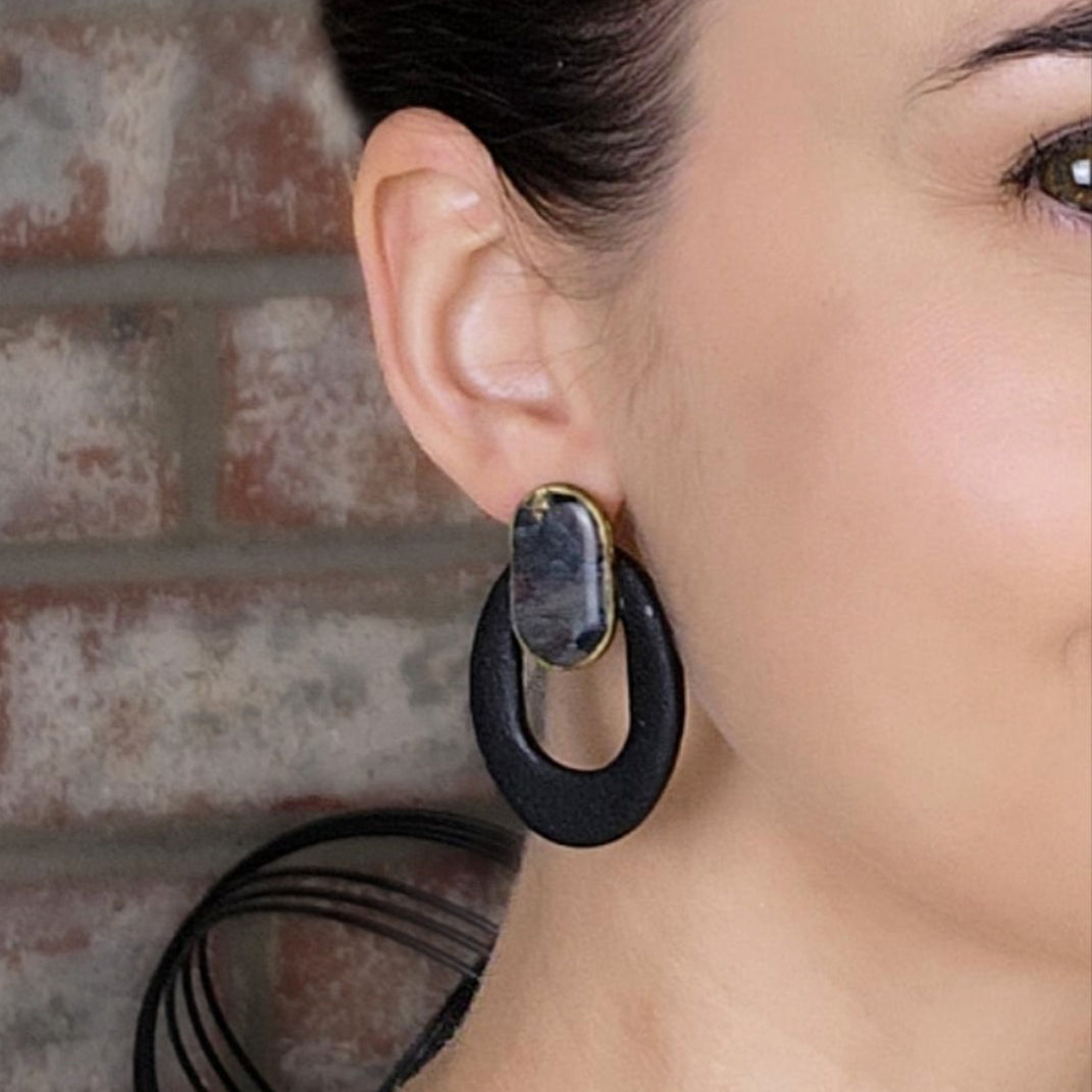 Black oval earrings with a clay stone stud